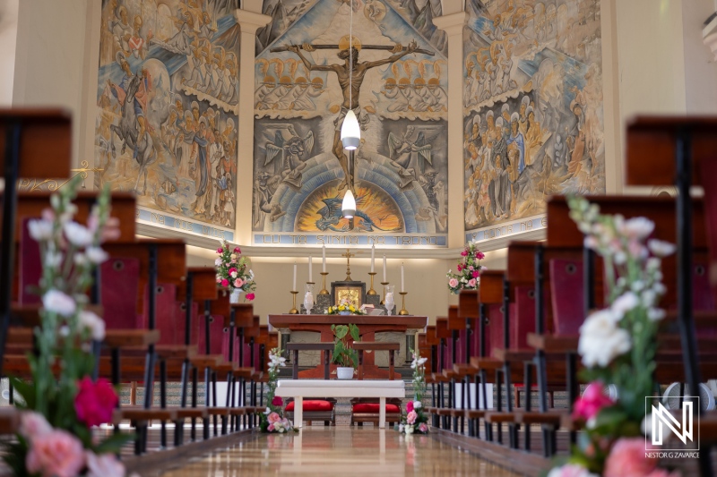 Inside a Beautifully Adorned Chapel Showcasing Intricate Wall Murals, Floral Arrangements, and a Central Altar During a Serene Moment of Reflection