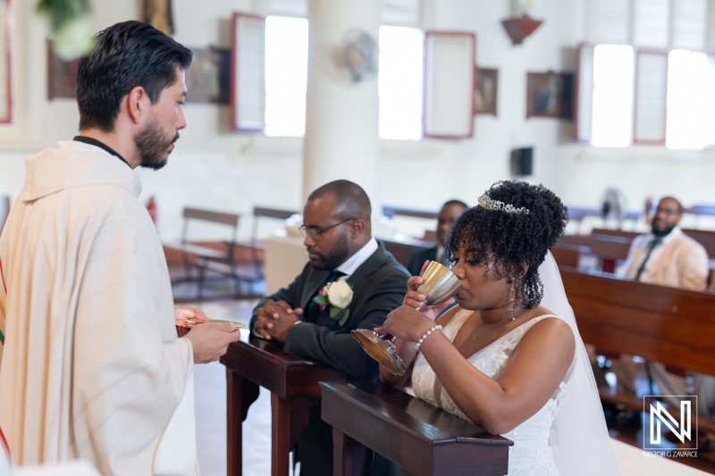 A Couple Participates in a Traditional Wedding Ceremony Inside a Beautiful Church With Elegant Architecture During an Intimate Gathering of Family and Friends