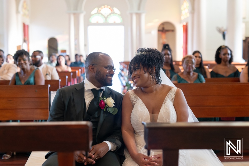 Joyful Couple Exchanges Loving Glances During Their Wedding Ceremony Inside a Charming Church Filled With Family and Friends in the Afternoon Light