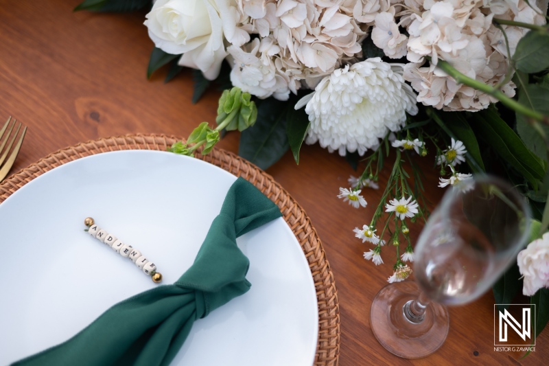 Elegant Table Setting With a Green Napkin and Floral Centerpiece for a Special Dining Occasion in a Beautifully Arranged Setting