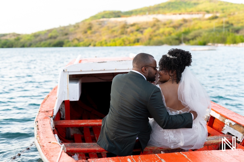 A Couple Shares a Romantic Moment on a Boat in a Serene Lake During Their Wedding Celebration in a Beautiful Outdoor Setting Surrounded by Nature