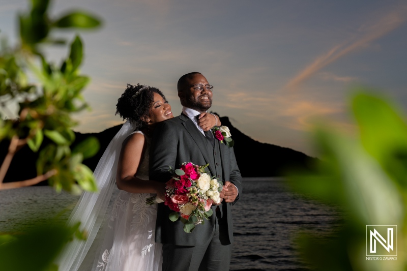 A Joyful Couple Embraces at Sunset Near a Tranquil Lake, Surrounded by Lush Greenery, Celebrating Their Love on Their Wedding Day