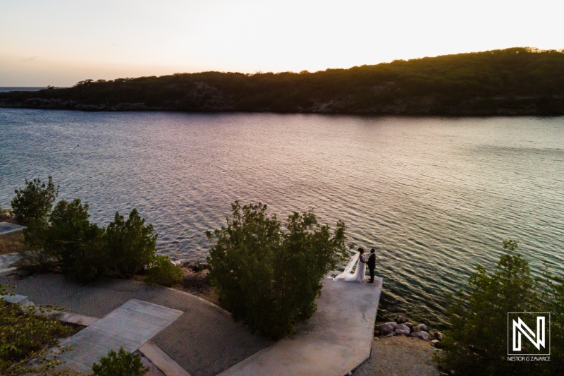 Couples Enjoy a Serene Sunset by the Water\'s Edge With Lush Greenery in the Background, Capturing a Moment of Connection and Tranquility