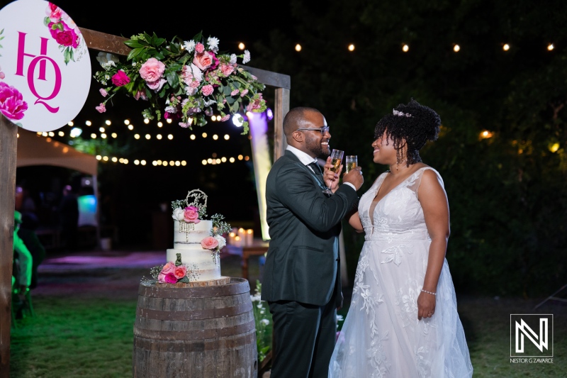 A Joyful Couple Celebrates Their Wedding Ceremony Under Twinkling Lights in an Enchanting Outdoor Venue Adorned With Flowers and Decorations