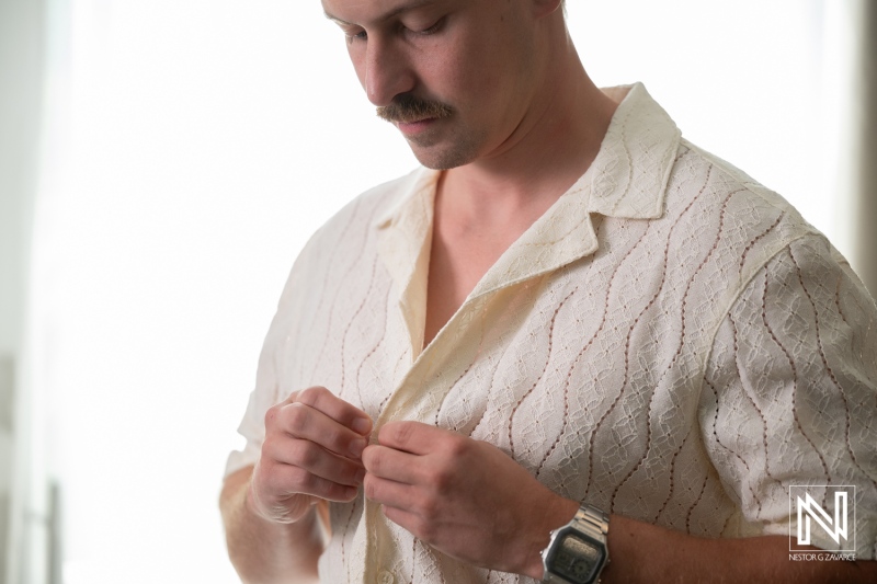 Groom prepares for wedding ceremony at Avila Beach Hotel in Curacao on a sunny day