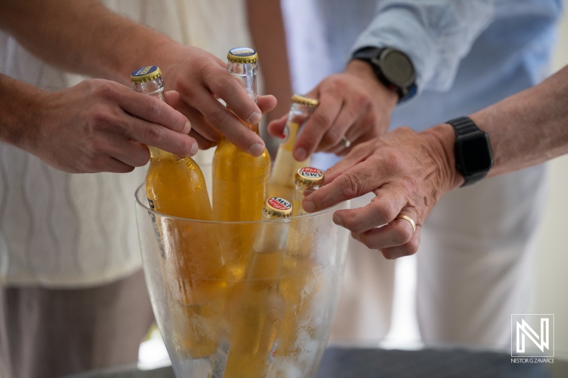 Celebration of a wedding at Avila Beach Hotel in Curacao with guests enjoying drinks by the beach