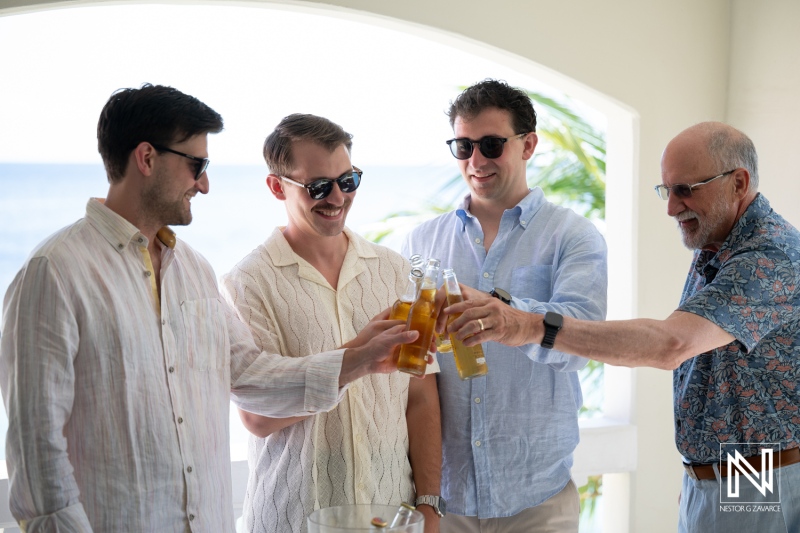 Friends celebrate at a wedding gathering in Curacao during a sunny day at Avila Beach Hotel