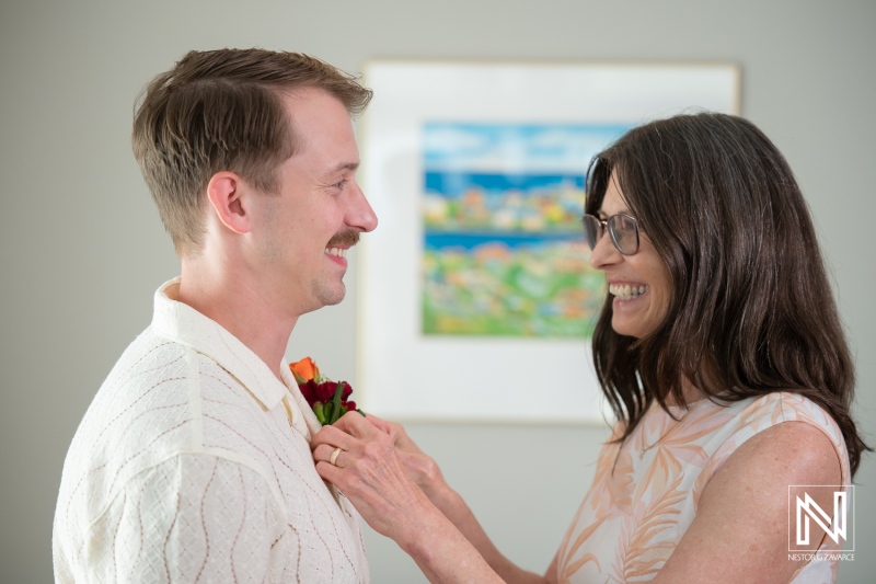 Couple prepares for wedding ceremony at Avila Beach Hotel in Curacao with smiles and joy