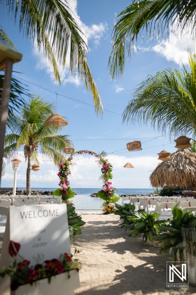Wedding ceremony setup at Avila Beach Hotel in Curacao with floral decorations and beach view