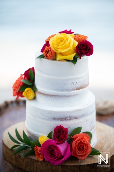 Wedding cake with flowers at Avila Beach Hotel in Curacao during a sunset celebration