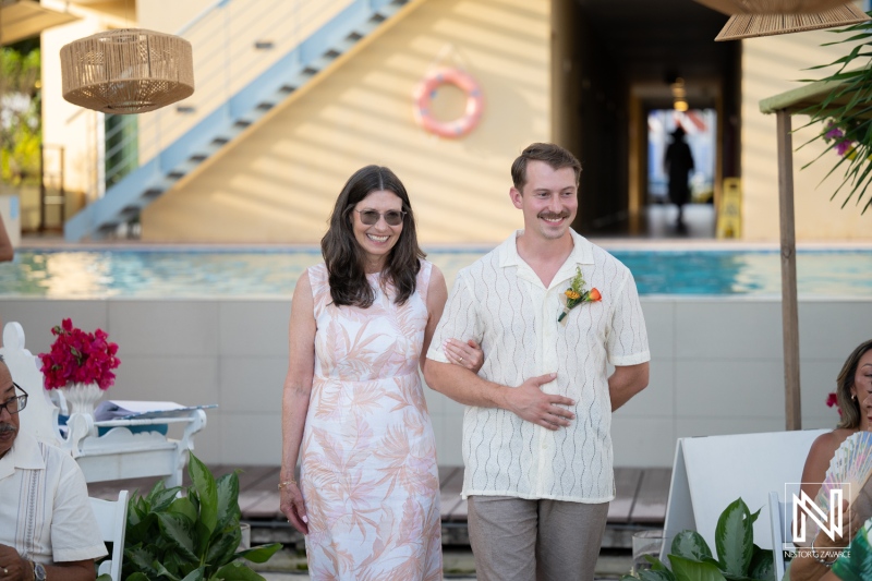 Couple walks down aisle at wedding ceremony held at Avila Beach Hotel in Curacao during sunny afternoon