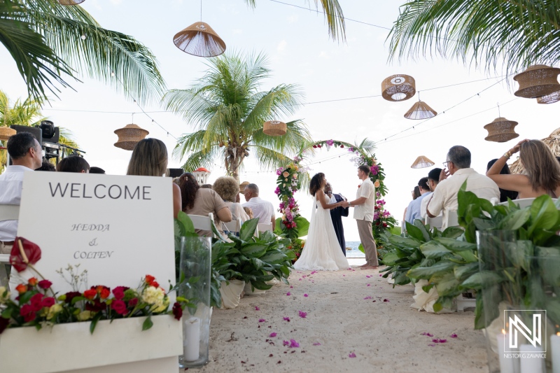 Wedding ceremony at Avila Beach Hotel in Curacao with guests celebrating on a sandy beach