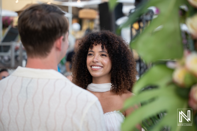Couple exchanges vows at Avila Beach Hotel in Curacao during a wedding ceremony surrounded by friends and family