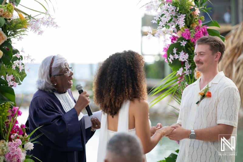 Wedding ceremony at Avila Beach Hotel in Curacao with a couple and officiant in a tropical setting