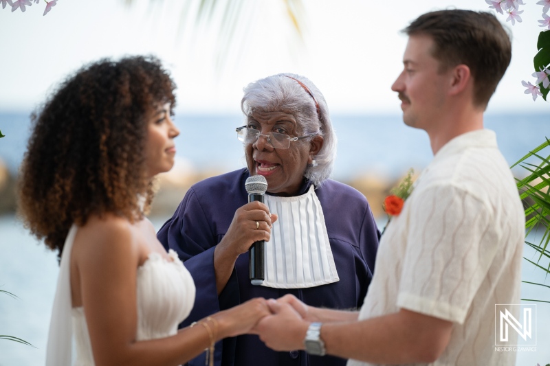 Couple exchanges vows during ceremony at Avila Beach Hotel in Curacao with officiant speaking to guests
