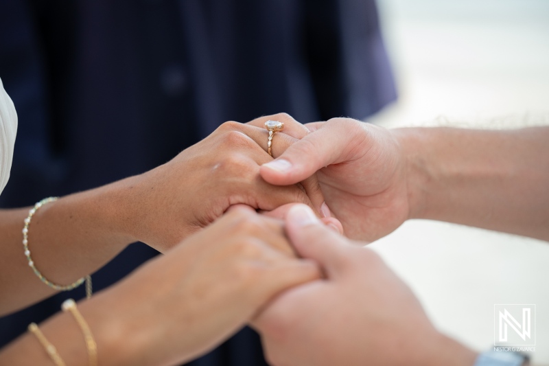 Wedding ceremony at Avila Beach Hotel in Curacao with couple holding hands and exchanging vows