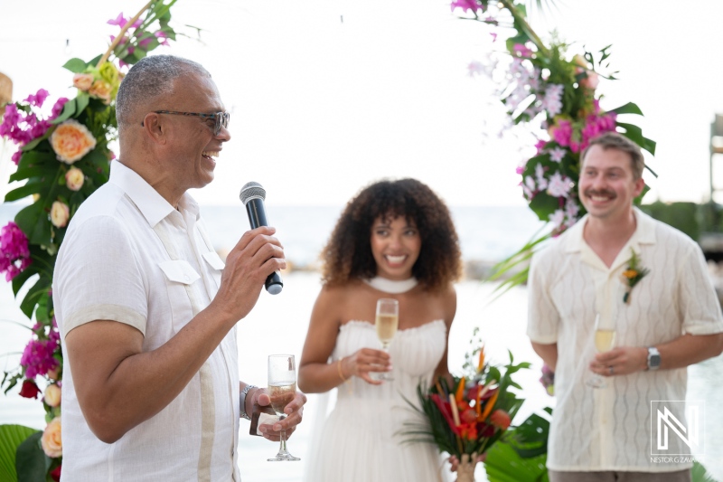Celebration of love at Avila Beach Hotel in Curacao during a joyful wedding ceremony with heartfelt speeches and toasts