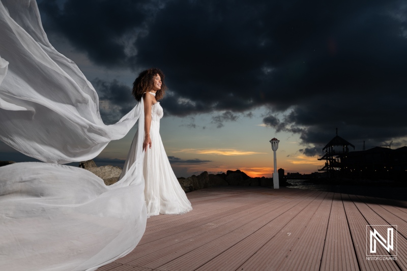 Wedding ceremony takes place at Avila Beach Hotel in Curacao during sunset with bride in flowy gown