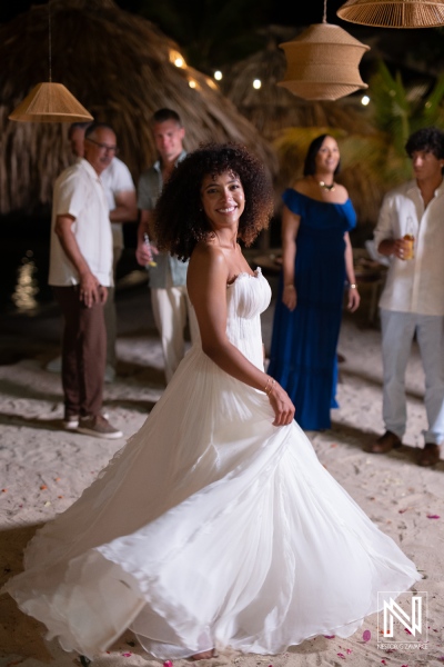 Guests celebrate a wedding at Avila Beach Hotel in Curacao during an evening event with laughter and joy among friends and family