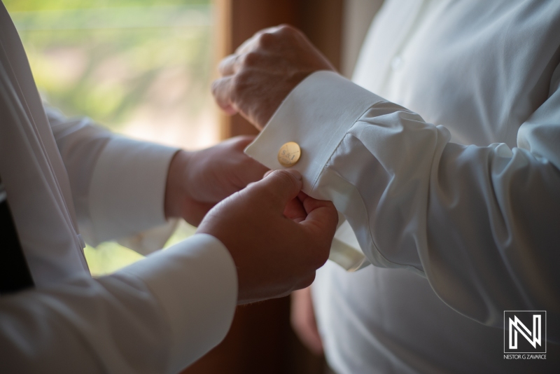 Groom getting into attire