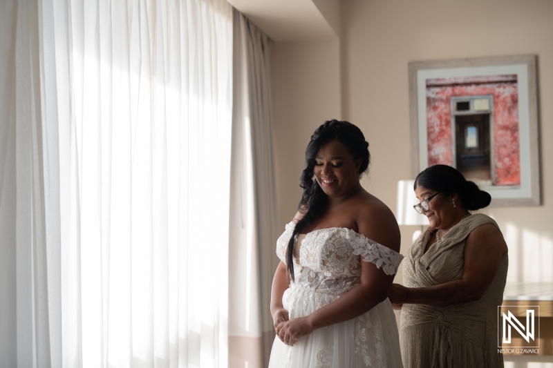 Bride getting into attire