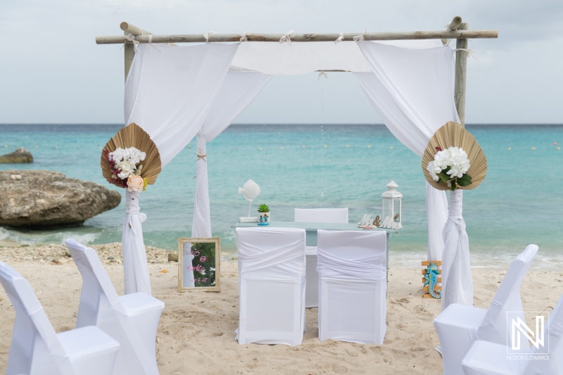 Destination wedding setup at Daaibooi Beach in Curacao with decorations and ocean view