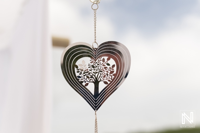 Elegant heart-shaped decor with tree design enhances the romantic setting for a destination wedding at Daaibooi Beach in Curacao