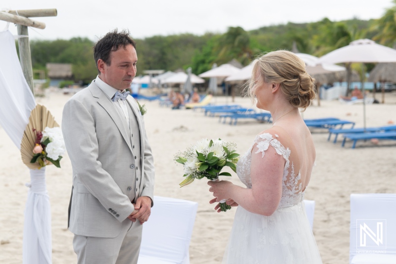 Couple exchanges vows during beautiful beach wedding ceremony at Daaibooi Beach, Curacao