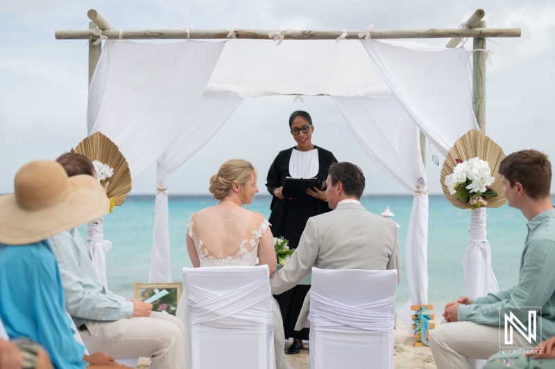 Destination wedding ceremony at Daaibooi Beach in Curacao by the ocean