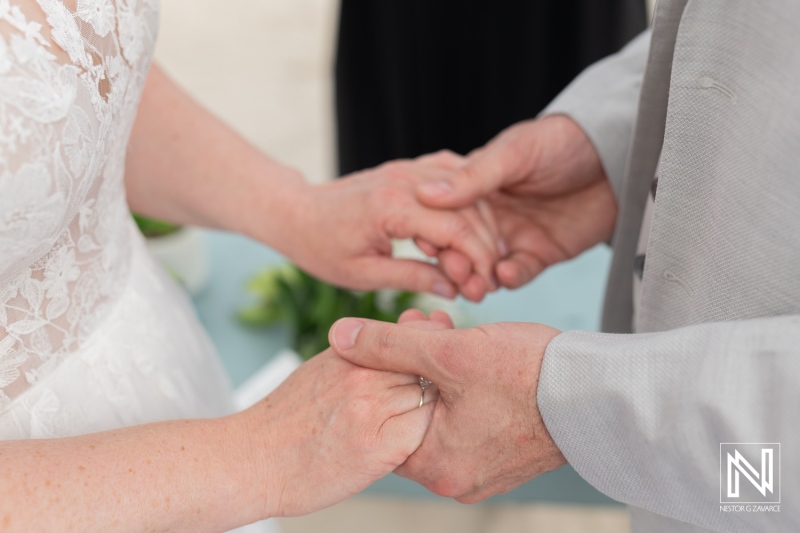 Couple exchanges vows during a destination wedding at Daaibooi Beach in Curacao under the tropical sun