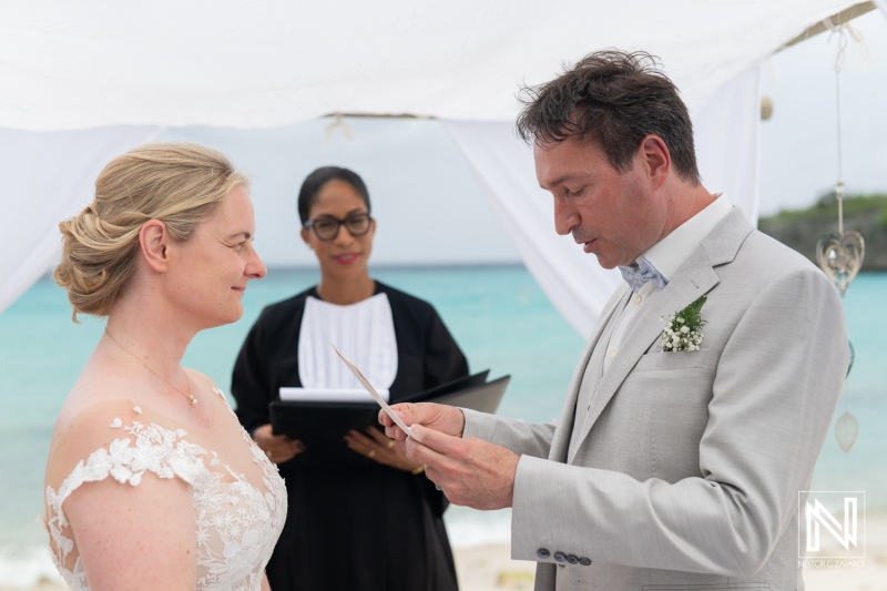 Destination wedding ceremony at Daaibooi Beach in Curacao with vows and beautiful ocean backdrop
