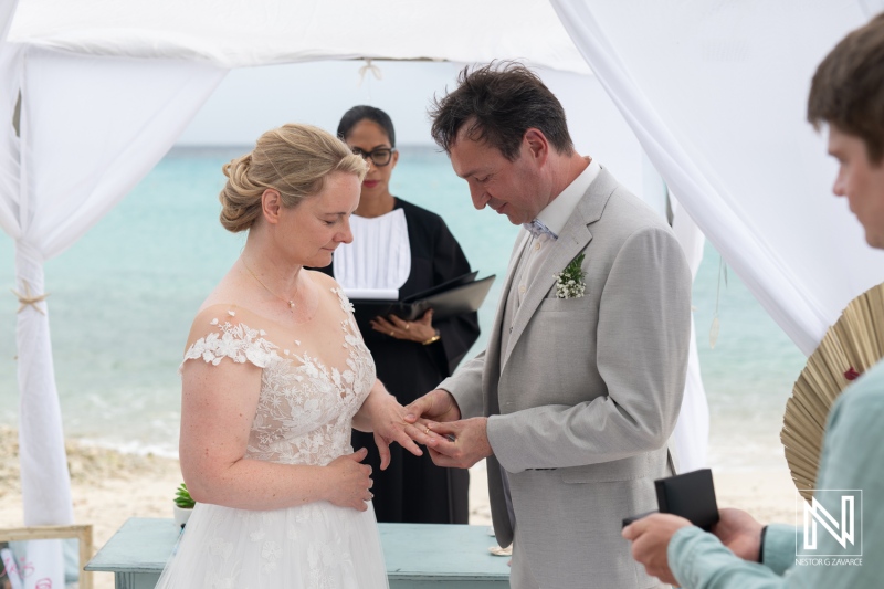 Beautiful wedding ceremony at Daaibooi Beach in Curacao with a loving couple exchanging vows by the sea