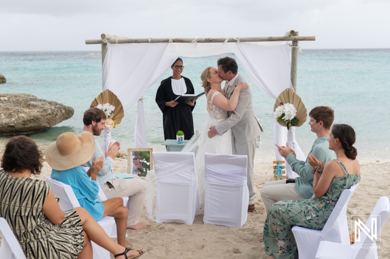 Couple shares a kiss during a beautiful wedding ceremony at Daaibooi Beach, Curacao