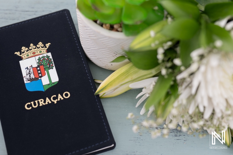 Celebrate love and joy at a stunning wedding on Daaibooi Beach in Curacao with vibrant flowers and a beautiful seaside backdrop