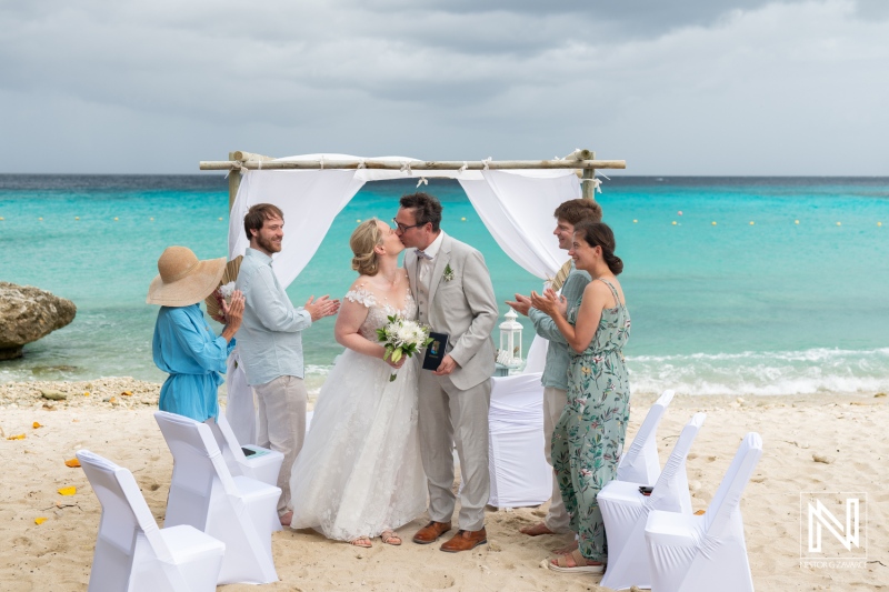 Couple exchanges vows with ocean backdrop during destination wedding at Daaibooi Beach in Curacao