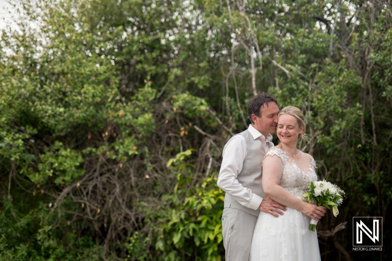 Couple shares a romantic moment during their destination wedding at Daaibooi Beach in Curacao