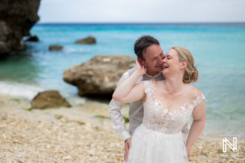 Couple celebrates their love at a romantic wedding on Daaibooi Beach in Curacao with stunning ocean views