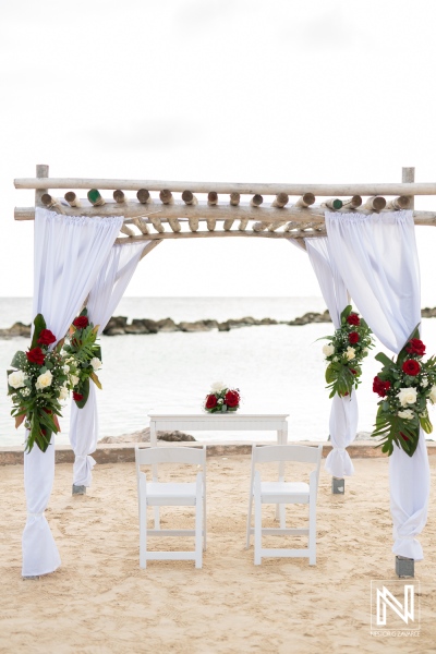Wedding ceremony setup at Sunscape Curacao Resort features elegant floral arrangements and a serene beach backdrop