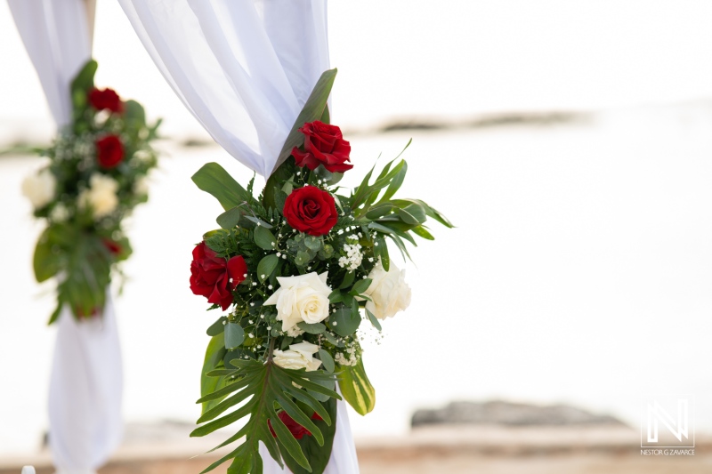 Beautiful floral arrangements decorate a wedding ceremony setup at Sunscape Curacao Resort, creating a romantic atmosphere of love and celebration