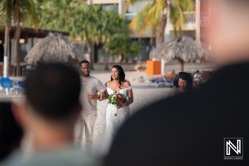 Celebration of love at a beach wedding in Curacao, with a beautiful couple and joyful guests embracing the moment at Sunscape Curacao Resort