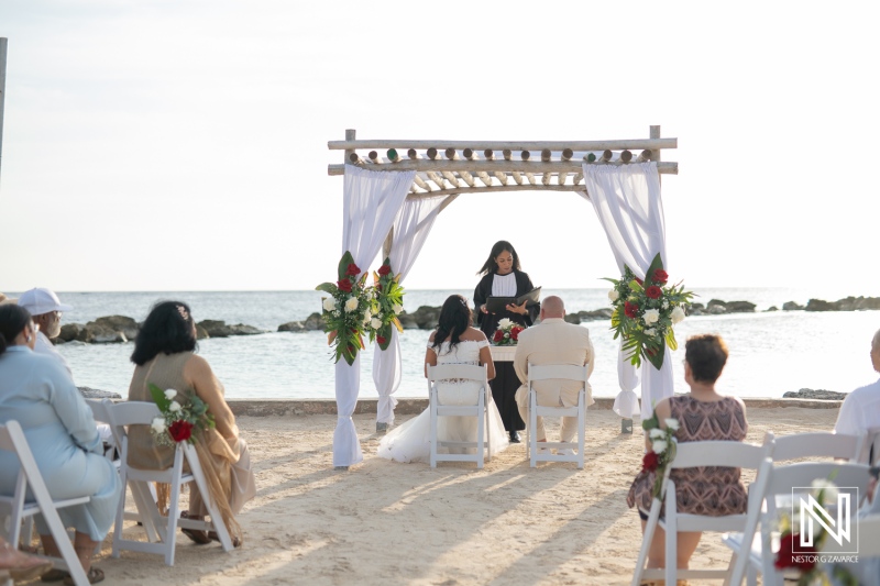 Couple exchanges vows during a beautiful beach wedding ceremony at Sunscape Curacao Resort overlooking the ocean