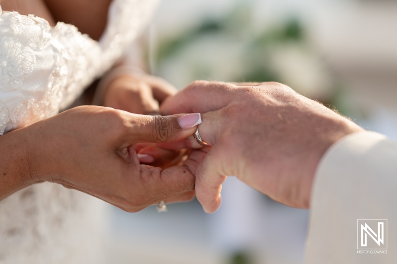 Bridal couple exchanges rings during a heartfelt ceremony at Sunscape Curacao Resort in a tropical paradise setting