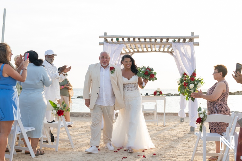 Couple celebrates their wedding ceremony at Sunscape Curacao Resort with family and friends on a beautiful beach setting