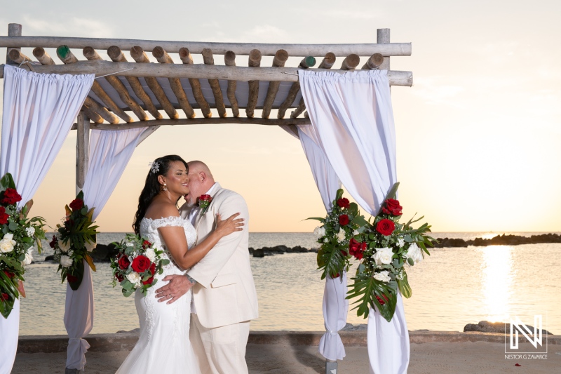 Couples joyfully celebrate their wedding at Sunscape Curacao Resort during a stunning sunset on the beach