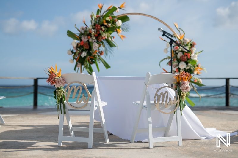 Celebrating love at sunset during a wedding ceremony at a beautiful resort in Curacao surrounded by vibrant floral decor
