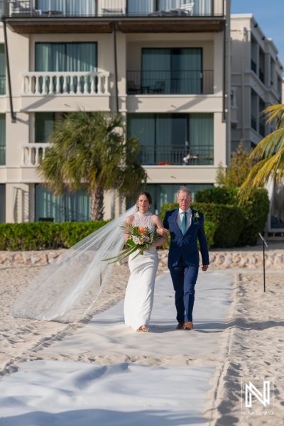 Ceremony celebration at sunset on the beach with bride and father at a beautiful Caribbean resort in Curacao