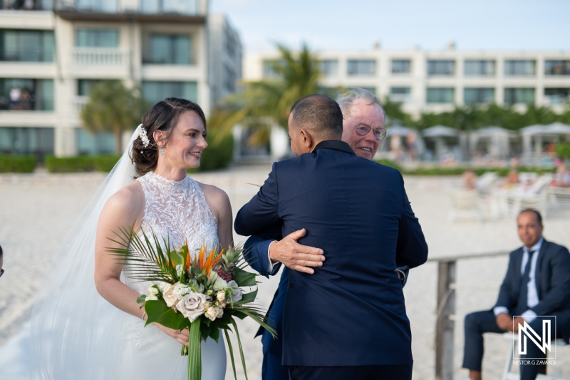 Romantic wedding ceremony at Curacao Marriott Beach Resort during sunset overlooking the beach