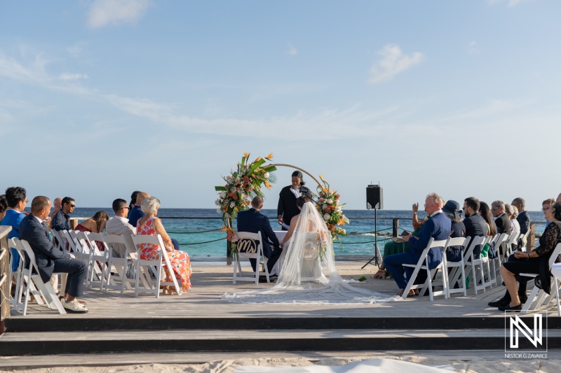 Beautiful sunset wedding ceremony at Curacao Marriott Beach Resort with stunning ocean backdrop