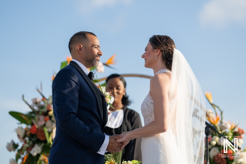 Couple exchanges vows during sunset ceremony at a beautiful wedding in Curacao Marriott Beach Resort