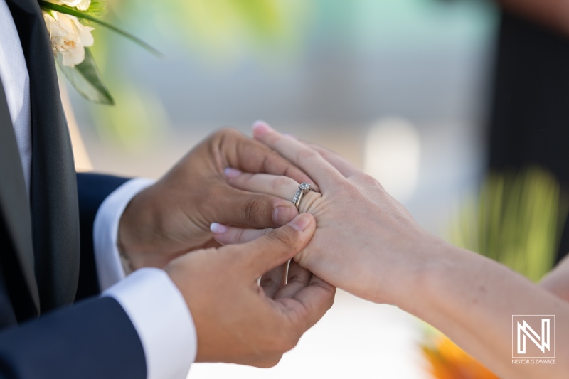 Exchanging vows during a romantic wedding ceremony at sunset in Curacao, providing a breathtaking backdrop at the beachfront resort